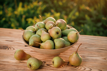Fresh ripe pear in the basket on wooden table with natural orchard background on sunset. Vegetarian fruit composition. Harvesting concept