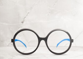 Vintage stylish black eyeglasses on desk