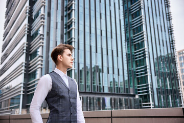 Young businessman against an urban background.