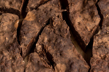 Pieces of chocolate with added cocoa and sugar