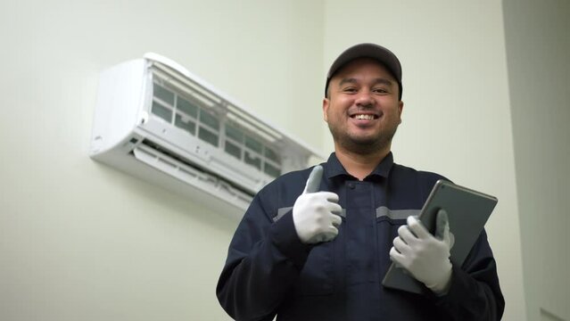 Portrait Technician in uniform check and cleaning filters of air conditioner. Air condition maintenance service. Home services concept.