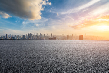 Fototapeta na wymiar Asphalt road and city skyline with modern buildings at sunset in Shanghai, China.