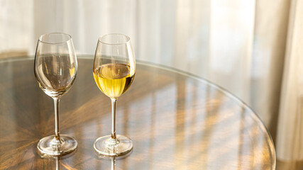 white wine glasses. Double gold champagne beverage for lover honeymoon on the luxury wooden table for cozy relax in holiday. new year romantic dinner drink for marriage wedding at home resort