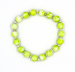 handmade bracelet made of green and silver beads, Delicate green beads in bracelet on hand of man and woman.