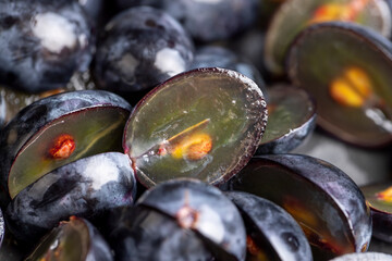 sweet ripe black grapes cut in half