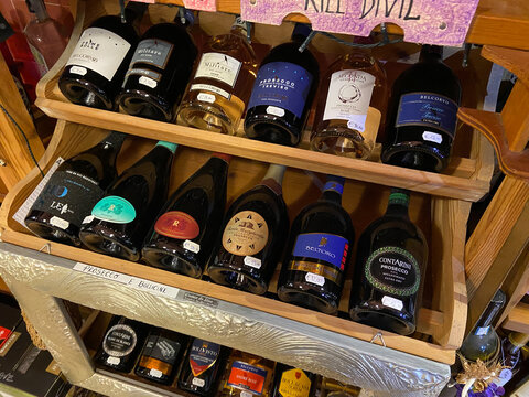 Venice, Italy - February 13, 2023: various italian prosecco bottles on shelf in local wine shop in Venice city