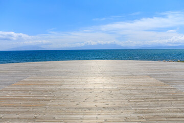 Empty wooden square with clear lake natural background in Xinjiang, China.