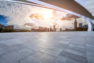 Empty square floor and city skyline with modern buildings at sunset in Ningbo, Zhejiang Province, China.