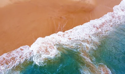 Foto op Canvas Aerial view of the waves with foam on the sandy ocean shore. Beautiful texture background for tourism and design. Tropical seashore © Payllik
