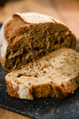 Close-up of dark rye bread cut on a wooden board