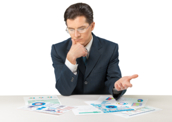 Young businessman sitting at desk and looking in chart