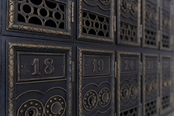 Vintage mailboxes. Old retro cells made of metal. Antique letter boxes. Copper mailboxes in the post office.