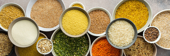 Various grain cereals in bowls banner, top view