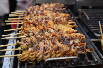 The Chinese area called Yaowarat, Bangkok, Thailand, where tourists from all over the world want to come and taste food such as Fresh squid salad or grilled. Taken on 19 Feb 2023.