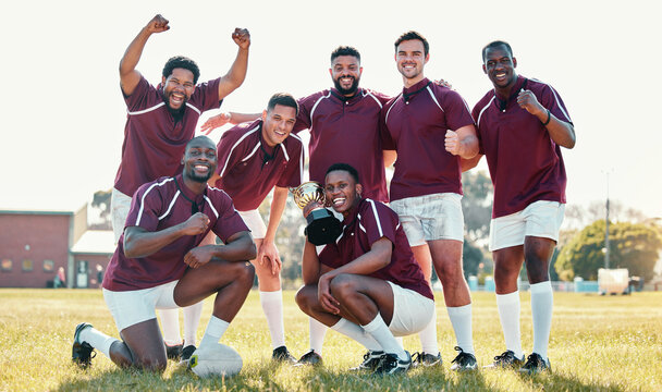 Sports, winner and rugby team with trophy in celebration for winning match, game and competition. Fitness, success and portrait of sport players celebrate victory, goals and achievement on field