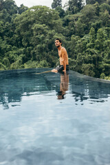 Man sitting on the edge of swimming pool