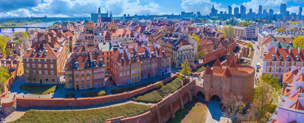 Warsaw, Poland Historic cityscape skyline roof with colorful architecture buildings in old town market square and church tower with blue sky