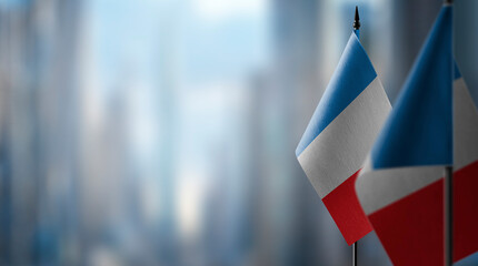 Small flags of the France on an abstract blurry background