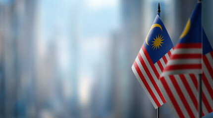 Small flags of the Malaysia on an abstract blurry background