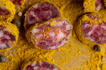 Sliced pork salami with spices and lots of turmeric