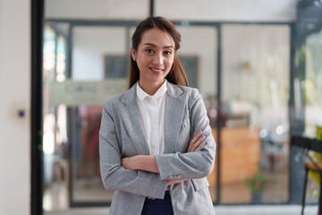 Female employee with coffee at workplace. Businesswoman preparing economic report.