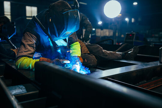 Industry worker welding iron at work