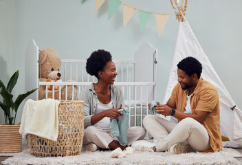 Pregnant and baby room and black couple happy to prepare for a family home and folding clothes. Man and woman together talking about excited pregnancy future, love and life insurance on bedroom floor