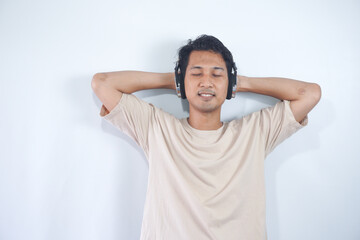 Peaceful positive modern man have black wireless headset listen music enjoy song melody close eyes feel pleasure wear casual style clothes isolated over white color background