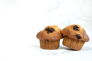 A stack of delicious chocolatechip banana muffins and blueberries on a white background, tasty healthy snack granola breakfast muffin