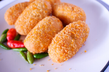 croquettes with cayenne pepper on a white plate