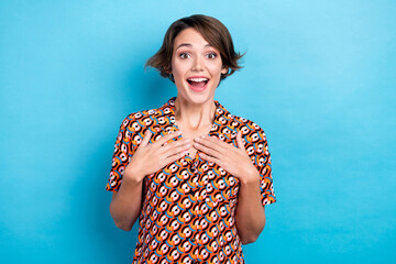 Photo of impressed funny lady dressed print shirt arms chest smiling open mouth isolated blue color background - obrazy, fototapety, plakaty
