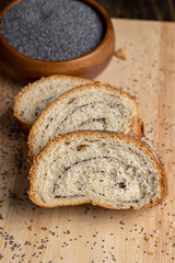 Poppy seeds and a bun with poppy seeds on the table