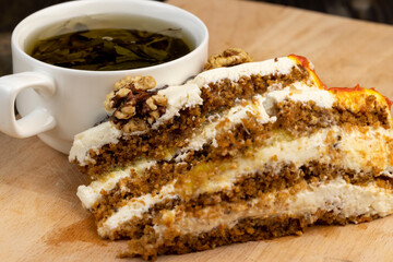 a cut piece of multi-layered honey cake with creamy filling