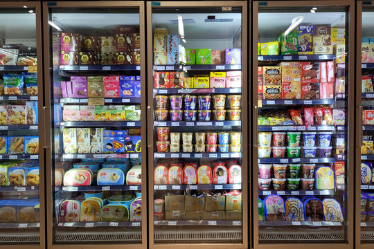 PENANG, MALAYSIA - 22 FEB 2023: Interior view of huge glass fridge with various brand ice cream in Jaya Grocer store. Jaya Grocer is the coolest fresh premium supermarket in Malaysia.