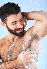 Obraz na płótnie Canvas Showering, man and foam with arm pit, cleaning and skincare for dermatology and wet body against blue studio background. Male, gentleman and morning routine for daily hygiene and grooming on backdrop