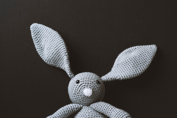 Hand crochet Easter bunny toy on black background