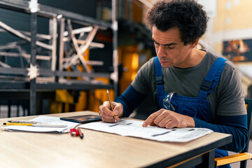 Naklejka premium A worker checks the quantities of a large order for a client in the workshop