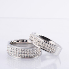 Two Diamonds Wedding Eternity Rings set on white background.