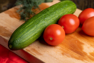 Ripe red tomatoes on a wooden chopping board