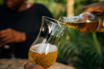 Two queer masculine women having a beer