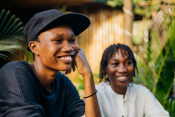 Two queer masculine black women in a garden