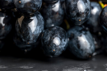 sweet ripe black grapes covered with drops of water