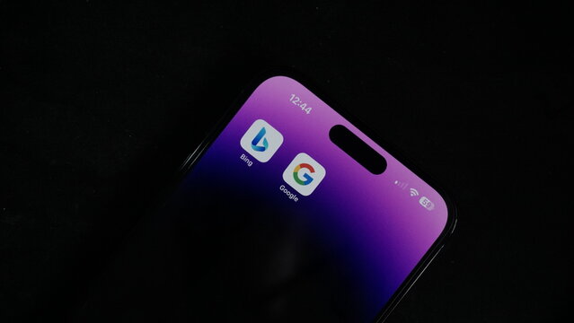 Ai war,  Bing vs Google. Google vs Microsoft, Bard vs ChatGPT. Iphone 14 pro max in the dark background