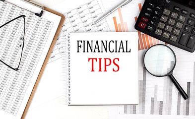 FINANCIAL TIPS ext on notebook with clipboard and calculator on a chart background