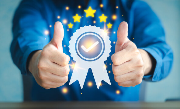 Businessman guarantee on customer service or business quality by thumb up with virtual medal icon. Quality assurance, certification and standardization concept.