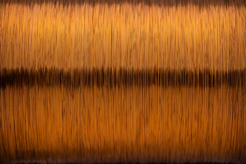 Metal texture of a coil of copper wire, closeup. Coil of thin copper wire on background