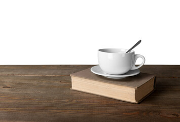 Cup of coffee with book on wooden table