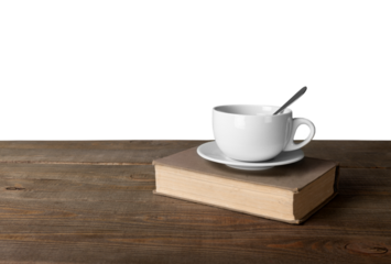 Cup of coffee with book on wooden table
