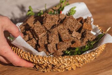 Homemade black rye cereal bread in a wicker basket in a traditional street food market, close up