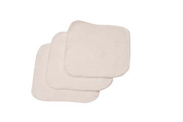 Stack of white cotton sponges isolated on a white background.